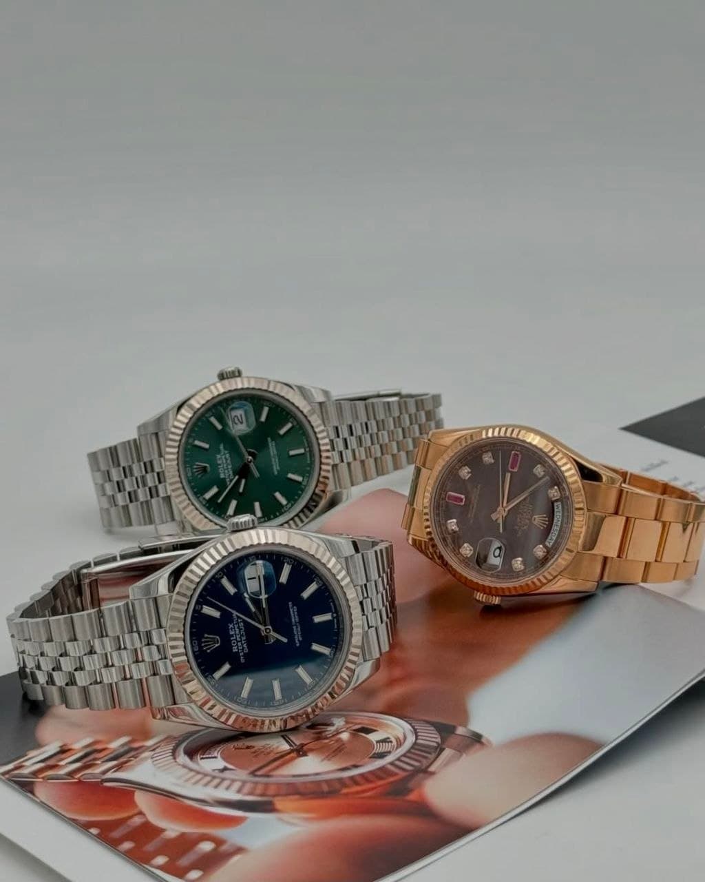 Rolex Datejust and Day-Date watches arranged on a magazine